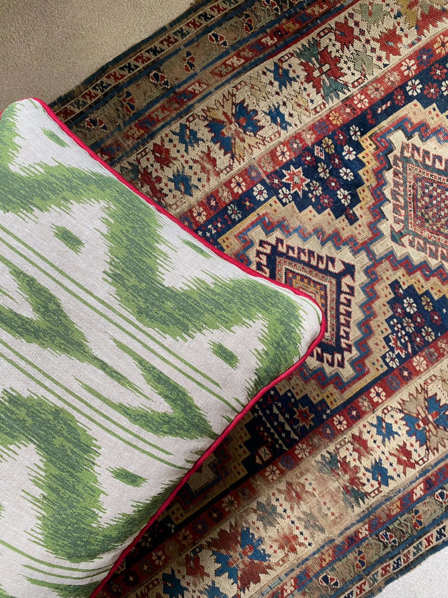 Green geo + red piping Cushion